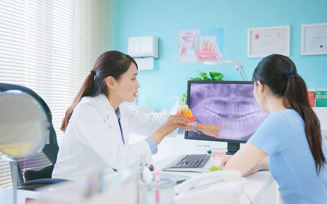 dentist and patient looking at x-rays - Smile Solutions of Maine